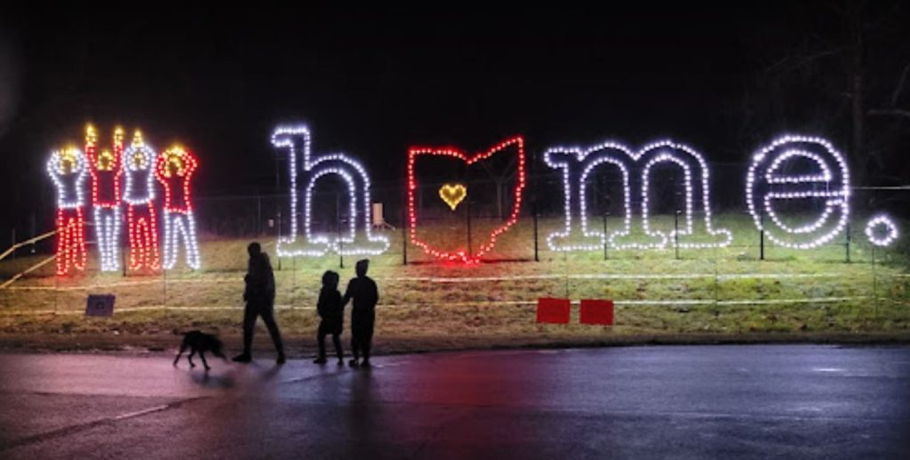 An image of a lit up sign that says "home" with the shape of Ohio standing in for the "o".