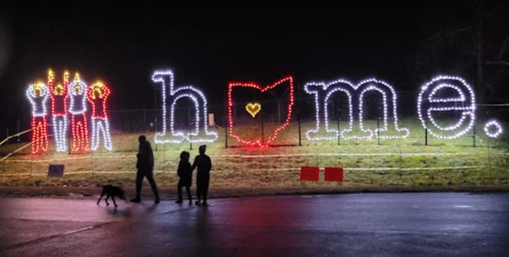 An image of a lit up sign that says "home" with the shape of Ohio standing in for the "o".