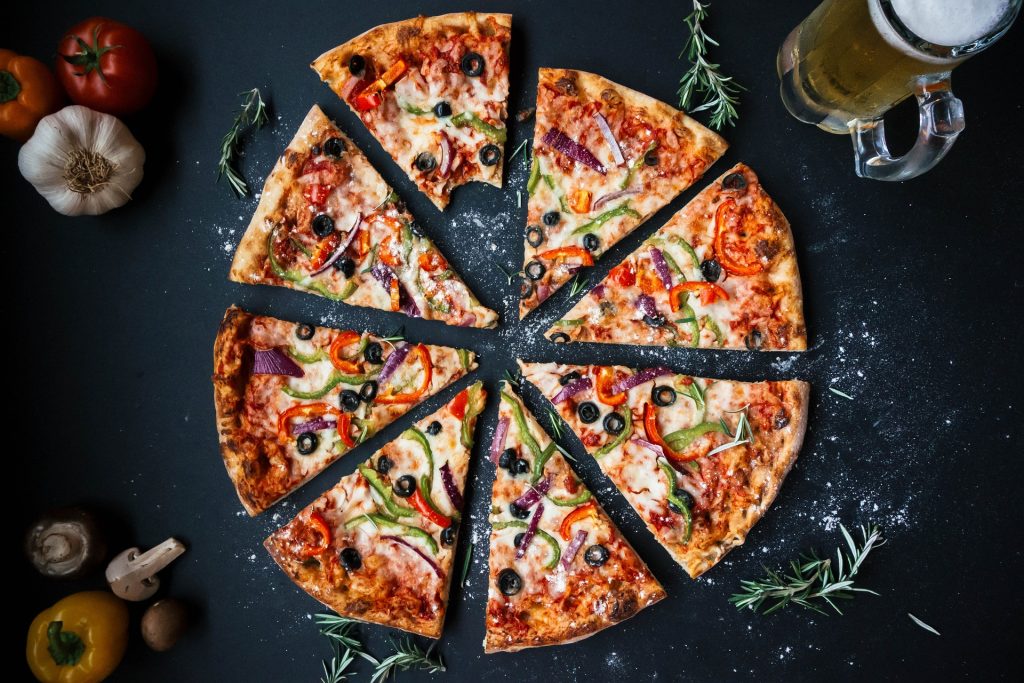 Overhead shot of a pizza cut into eight separate slices.