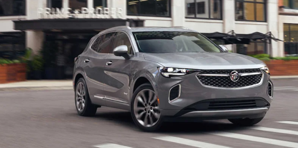 A gray 2022 Buick Envision driving down a road.