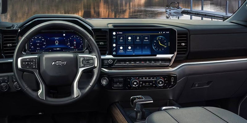 The dashboard of a 2024 Chevy Silverado 1500, featuring luxury trims.
