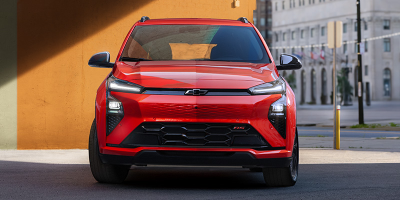 Red Chevrolet Equinox RS SUV parked in an urban setting
